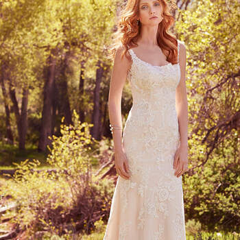 Striking lace appliqués cascade from the embellished straps to delicate hem in this romantic sheath, accented with beading, Swarovski crystals, and shimmering sequins. Featuring a classic scoop neckline and illusion back accented with lace appliqués. Finished with crystal buttons over zipper closure. 
<a href="https://www.maggiesottero.com/maggie-sottero/phoebe/10133?utm_source=mywedding.com&amp;utm_campaign=spring17&amp;utm_medium=gallery" target="_blank">Maggie Sottero</a>