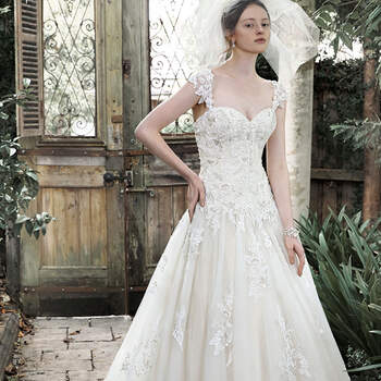 Elegance and romance combine to create this dreamy ball gown. Exquisite lace, accented with pearl embellishments, adorns a fitted bodice before flaring into a voluminous tulle skirt, edged in delicate lace. Complete with sweetheart neckline, optional lace cap-sleeves and corset closure.

<a href="http://www.maggiesottero.com/dress.aspx?style=5MT648" target="_blank">Maggie Sottero</a>