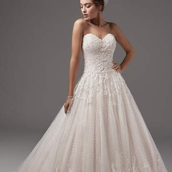 Beaded lace appliqués dance across the bodice and illusion back of this shimmering ballgown, while a striking lace hem and layers of tulle crosshatching add texture and dimension to the skirt. Featuring a scalloped sweetheart neckline. Finished with covered buttons and zipper closure. 
<a href="https://www.maggiesottero.com/sottero-and-midgley/jewel/10232?utm_source=mywedding.com&amp;utm_campaign=spring17&amp;utm_medium=gallery" target="_blank">Sottero and Midlgey</a>