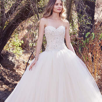 This enchanting ballgown features a strapless bodice of beaded lace appliqués and Swarovski crystal embellishments. A soft sweetheart neckline and voluminous layers of tulle evoke fairytale romance. Finished with covered buttons over zipper and inner corset closure.
