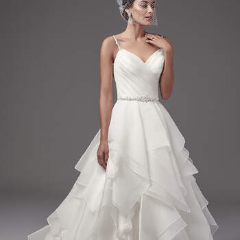 This glamorous ballgown features a pleated bodice and tiered layers of Marquice organza. Swarovski crystals and beading adorn the spaghetti straps, statement back detailing, and waistline. Finished with sweetheart neckline, crystal buttons and zipper closure. 
<a href="https://www.maggiesottero.com/sottero-and-midgley/blaire/10209?utm_source=mywedding.com&amp;utm_campaign=spring17&amp;utm_medium=gallery" target="_blank">Sottero and Midgley</a>