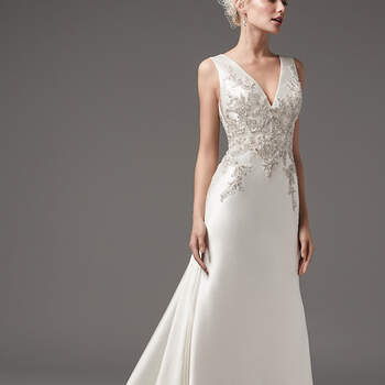 This chic and sexy Yaron Mikado sheath features exquisite bead and Swarovski crystal embellishments along the bodice. Featuring a V-neckline and square back with beaded lace illusion detail atop a glamorous tunnel train. Finished with pearl buttons and zipper closure. 
<a href="https://www.maggiesottero.com/sottero-and-midgley/clayton/10214?utm_source=mywedding.com&amp;utm_campaign=spring17&amp;utm_medium=gallery" target="_blank">Sottero and Midgley</a>