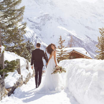 Wedding couple walking in winter village, Mürren