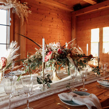 Decoration wedding dinner in an alpine hut, Engadin St. Moritz with flowers and candle and wood