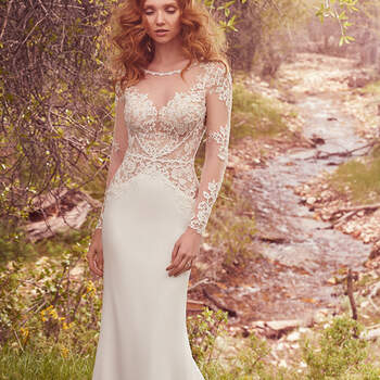Robe longue à manches longues effet transparent.
<a href="https://www.maggiesottero.com/maggie-sottero/blanche/10089?utm_source=mywedding.com&amp;utm_campaign=spring17&amp;utm_medium=gallery" target="_blank">Maggie Sottero</a>