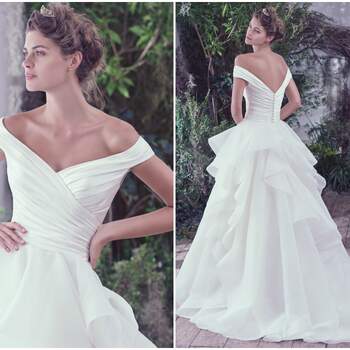 Asymmetrically pleated L’Amour satin creates a refined fitted bodice before flaring into a sculptured Venice organza ball gown skirt featuring horsehair edged layers. Off-the-shoulder sleeves create a portrait neckline flaunting an exquisitely romantic style. Finished with covered buttons over zipper closure.

<a href="https://www.maggiesottero.com/maggie-sottero/zulani/9752" target="_blank">Maggie Sottero</a>