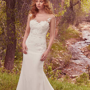 This gorgeous sheath features a bodice embellished with lace appliqués and delicate pearls and Swarovski crystals, flowing into a simple Sylvie crepe skirt. An illusion sweetheart neckline complements an illusion keyhole-back accented in lace appliqués. Finished with covered buttons over zipper closure. 
<a href="https://www.maggiesottero.com/maggie-sottero/dion/10097?utm_source=mywedding.com&amp;utm_campaign=spring17&amp;utm_medium=gallery" target="_blank">Maggie Sottero</a>