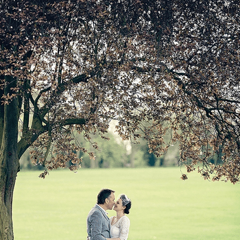 Los novios besándose en un precioso parque.