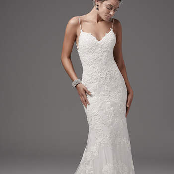 Chic and alluring, this tulle fit-and-flare features shimmering lace appliqués and bead detailing over Inessa jersey. Gorgeous criss-cross strap details accent the gown's open back, completing the shoulder strap V-neckline. Finished with zipper closure. 
<a href="https://www.maggiesottero.com/sottero-and-midgley/bristol/10210?utm_source=mywedding.com&amp;utm_campaign=spring17&amp;utm_medium=gallery" target="_blank">Sottero and Midgley</a>