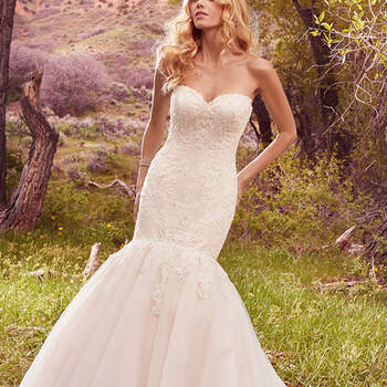 Beaded lace appliqués adorn crosshatched tulle on the bodice of this fairytale fit-and-flare, featuring a strapless sweetheart neckline and breathtaking tulle train. Finished with corset closure, or covered buttons over zipper and inner corset closure. Detachable cap-sleeves with lace appliqués sold separately. 
<a href="https://www.maggiesottero.com/maggie-sottero/keely/10111?utm_source=mywedding.com&amp;utm_campaign=spring17&amp;utm_medium=gallery" target="_blank">Maggie Sottero</a>