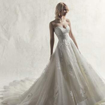 Embroidered lace motifs cascade over layers of sequin and textured tulle in this elegant princess wedding dress.