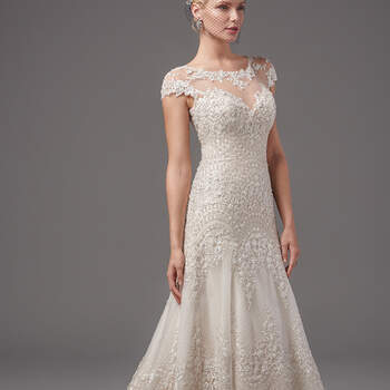 This regal A-line features scalloped patterns of embellished lace appliqués and exquisite crosshatching. Illusion bateau over sweetheart neckline, illusion cap-sleeves, and statement illusion-back accented in cascading lace appliqués add sensuality and romance. Finished with crystal buttons and zipper closure. 
<a href="https://www.maggiesottero.com/sottero-and-midgley/gigi/10226?utm_source=mywedding.com&amp;utm_campaign=spring17&amp;utm_medium=gallery" target="_blank">Sottero and Midgley</a>
