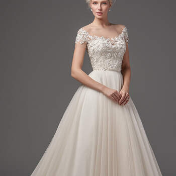 This glamorous bodice is embellished in lace appliqués, Swarovski crystals, and shimmering pearls. Illusion off-the-shoulder neckline adds intrigue and drama. Finished with crystal buttons over zipper closure. Ballgown skirt features voluminous layers of tulle and a tulle waistband. Finished with zipper closure.
<a href="https://www.maggiesottero.com/sottero-and-midgley/shayne---kallin/10299?utm_source=mywedding&amp;utm_campaign=spring2017&amp;utm_medium=gallery" target="_blank">Sottero and Midgley</a>