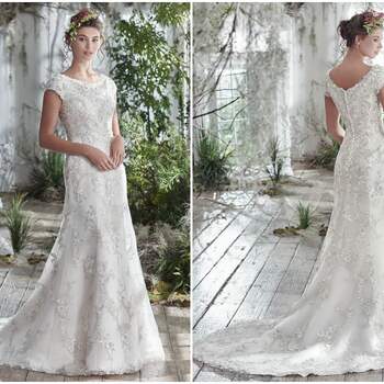 Intricately woven floral lace embellishments add dimension to this simultaneously elegant and classic sheath wedding dress. Additional lace details dust the illusion bateau neckline, cap-sleeves, and hemline. Finished with covered buttons over zipper and inner corset closure. 

<a href="https://www.maggiesottero.com/maggie-sottero/georgianna/9767" target="_blank">Maggie Sottero</a>