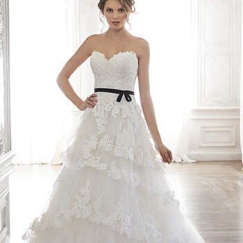 Sweet and feminine is this gorgeous tulle and lace ballgown, complete with a romantic sweetheart neckline. Layers of lace-lined tulle drift down a voluminous skirt. Optional grosgrain ribbon belt adorns the waist. Finished with covered button over zipper closure and inner corset.


<a href="http://www.maggiesottero.com/dress.aspx?style=5MW127" target="_blank">Maggie Sottero Spring 2015</a>