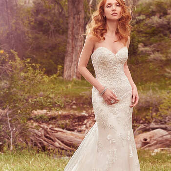 Lace appliqués cascade down this lightweight fit-and-flare, featuring an alluring sweetheart neckline and striking lace hem. Finished with corset closure, or crystal buttons over zipper and inner corset closure. Lace illusion off-the-shoulder jacket with short sleeves sold separately.
<a href="https://www.maggiesottero.com/maggie-sottero/reynold/10136?utm_source=mywedding.com&amp;utm_campaign=spring17&amp;utm_medium=gallery" target="_blank">Maggie Sottero</a>