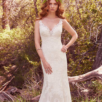 This elegant fit-and-flare features cascades of lace appliqués and a striking hemline. Scalloped lace illusion trims the deep V-neck and straps, and lines of lace appliqués accent the illusion back. Finished with covered buttons over zipper closure. 
<a href="https://www.maggiesottero.com/maggie-sottero/venita/10150?utm_source=mywedding.com&amp;utm_campaign=spring17&amp;utm_medium=gallery" target="_blank">Maggie Sottero</a>