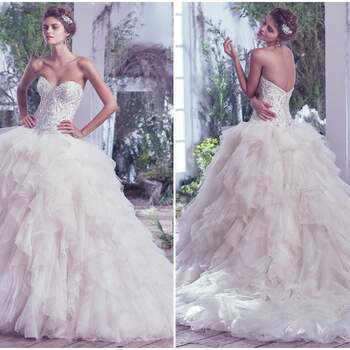 Airy tulle and Chic organza create the dreamy and alluring skirt of this grand ball gown wedding dress, artistically embellished with beading and Swarovski crystals, fitted bodice and romantic sweetheart neckline. Finished with covered buttons over zipper and inner corset closure. Available with extended train (16" longer), Castalia Marie.

<a href="https://www.maggiesottero.com/maggie-sottero/castalia/9688" target="_blank">Maggie Sottero</a>