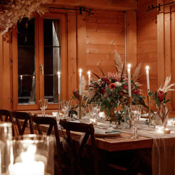Decoration wedding dinner in an alpine hut, Engadin St. Moritz with flowers and candle and wood