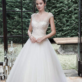 A lavish bead embroidered bodice, adorned with sparkling Swarovski crystals and sequins, finds balance with this unembellished tulle skirt, striking the quintessential modern romantic ball gown wedding dress, accented with illusion cap-sleeves, and scoop neckline and back. Finished with covered buttons over zipper closure.

<a href="http://www.maggiesottero.com/dress.aspx?style=5MB713" target="_blank">Maggie Sottero</a>

