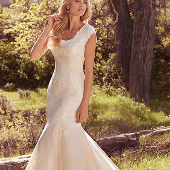 Classic and elegant, this modest fit-and-flare features layers of lace appliqués over airy tulle, a scalloped lace hemline, cap-sleeves, and a scoop neckline. Finished with covered buttons over zipper closure. 
<a href="https://www.maggiesottero.com/maggie-sottero/brielle/10165?utm_source=mywedding.com&amp;utm_campaign=spring17&amp;utm_medium=gallery" target="_blank">Maggie Sottero</a>