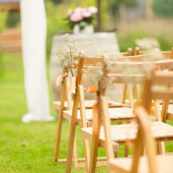 Las sillas de madera plegables ahorran espacio y son fáciles de transportar si quieres organizar una boda sencilla y al aire libre. Foto: 2Rings Trouwfoto