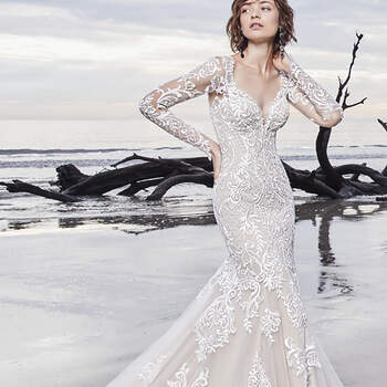 Gorgeous lace motifs cascade over tulle in this chic sleeved wedding gown, completing the illusion long sleeves, V-neckline, and illusion V-back. Fit-and-flare skirt features an illusion double-lace train. Lined with shapewear for a figure-flattering fit. Finished with with covered buttons over zipper closure.

<a href="https://www.maggiesottero.com/sottero-and-midgley/dakota/11529">Sottero and Midgley</a>