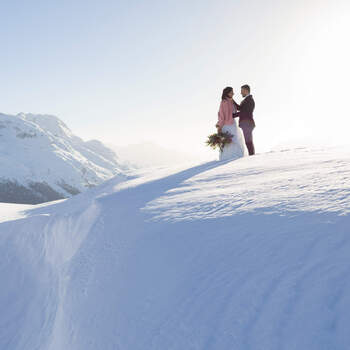 Wedding couple shooting in the mountain of Engadin in winter time with snow and panorama views