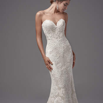 "This intriguing fit-and-flare features crosshatch netting and luxurious lace appliqués. Flourishes in the lace pattern evoke a basque waistline. Complete with
sexy sweetheart neckline and open V-back. Finished with covered buttons over zipper closure. "
<a href="https://www.maggiesottero.com/sottero-and-midgley/ellington/10217?utm_source=mywedding.com&amp;utm_campaign=spring17&amp;utm_medium=gallery" target="_blank">Sottero and Midgley</a>