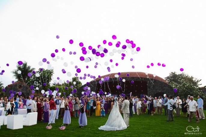 Los invitados y novios soltando globos morados en la recepción - Foto Arturo Ayala