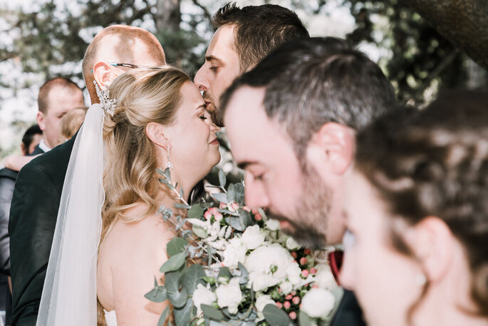 Sposo bacia in fronte la sposa