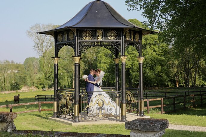 Les mariés sous une coupole dans les jardins du Château de Maudétour