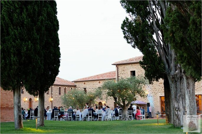 Une réception de mariage en extérieur à la tombée de la nuit dans un superbe parc, en Italie