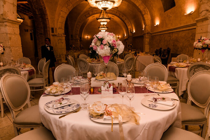 Table de mariage dressée dans une salle en pierres avec des voûtes