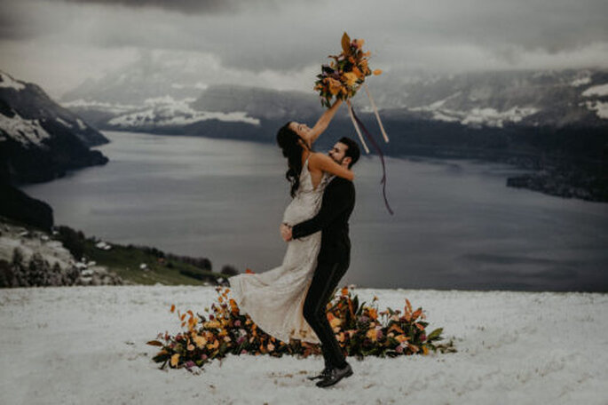 Brautpaar vor Schneekulisse mit Strauß