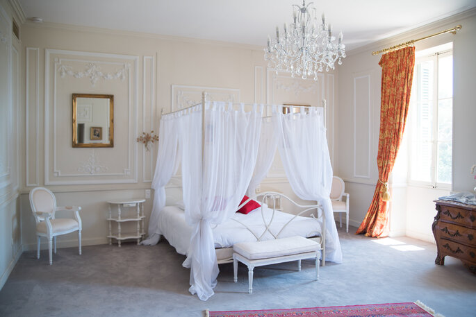 Une chambre avec un lit baldaquin où pourront dormir des invités après un mariage