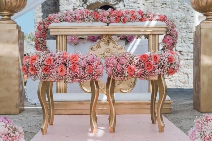 allestimento posti per gli sposi all'altare, rose rosa